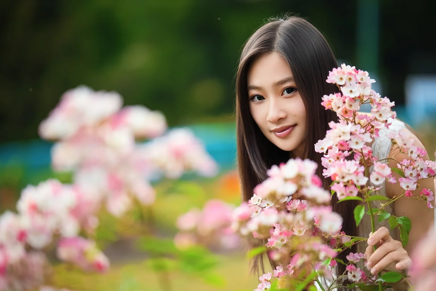 Natural-light portrait among pink flowers in Vancouver